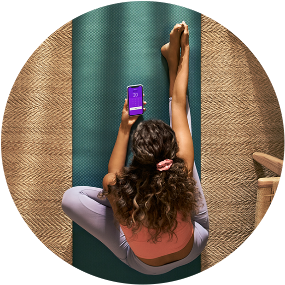 Woman Exercising and on a mobile phone using Zelle Pay app.