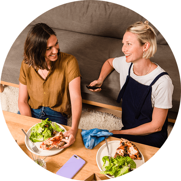 two women hang out and share food